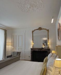 a bedroom with white walls and gold trim