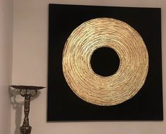 a black and gold painting hanging on the wall