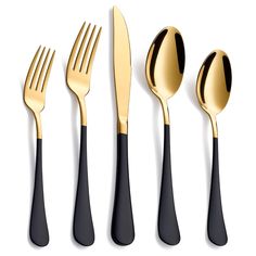 black and gold utensils are lined up on a white surface with one fork, the other knife and two spoons