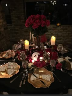 a table set with plates, silverware and candles for a formal dinner or party