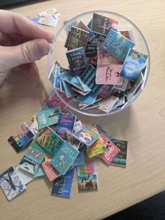 a glass bowl filled with lots of different colored cards