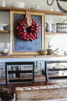 a wreath is hanging on the wall above a dining room table