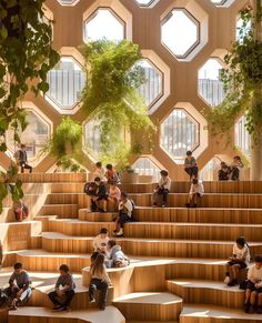 many people are sitting on the steps in an open area with large windows above them