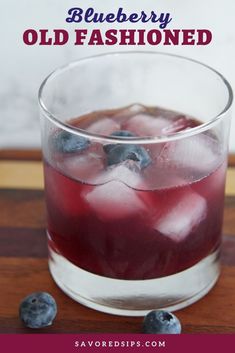 blueberry old fashioned drink in a glass with ice and berries