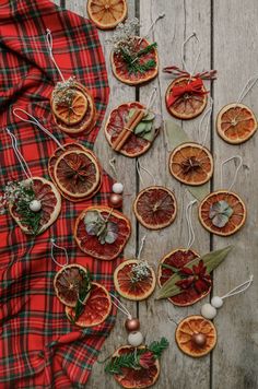 orange slices are arranged on a table with christmas decorations and ornaments around them, including an ornament