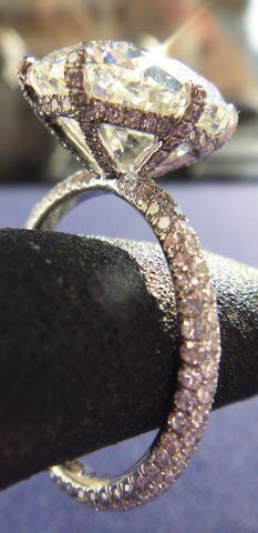 a diamond ring sitting on top of a black piece of cloth