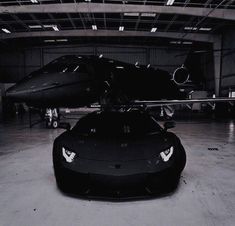 a black and white photo of a car in a hangar