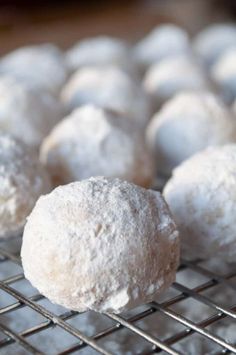 there are several balls of powdered sugar on the cooling rack