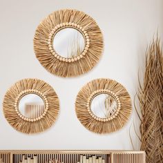 three circular mirrors mounted on the wall above a radiator