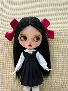 a doll with long black hair and big eyes