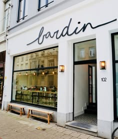 the storefront of a restaurant with tables and chairs in it's front window