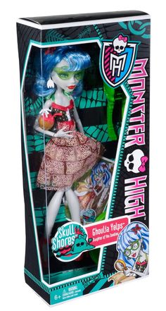 the monster doll is in its box and has blue hair, green eyes, and pink dress