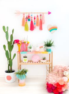 a table with some plants and other decorations on top of it next to a potted plant