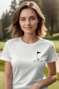 a woman wearing a white tee shirt that says for the win with a golf flag on it