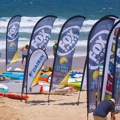 many surfboards are lined up on the beach