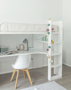 a white bunk bed sitting next to a desk