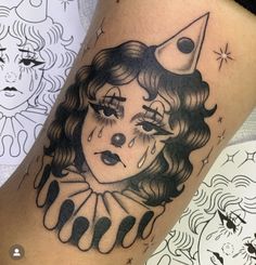 a woman's face with teary eyes and an upside down moon tattoo on her leg