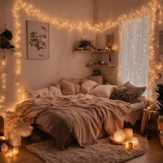 a bedroom with lights strung from the ceiling and blankets on the bed in front of it