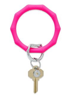 a pink keychain with a metal ring and two keys hanging from it's end