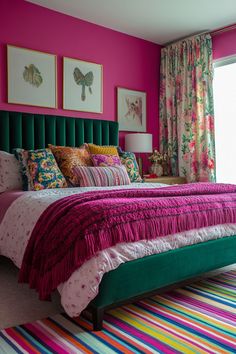 a colorful bedroom with pink walls and green headboard