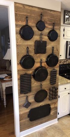 a kitchen with pots and pans mounted to the wall