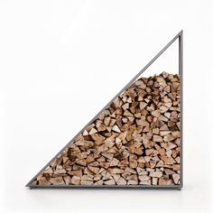 a pile of wood sitting inside of a metal triangle