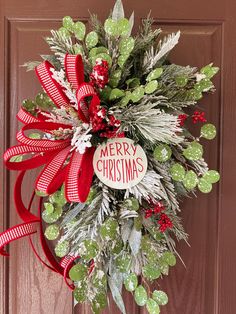 a christmas wreath hanging on the front door