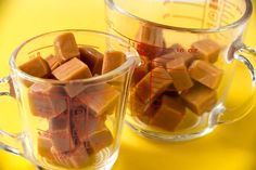 two mugs filled with chocolate sitting on top of a table