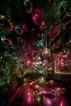 a room filled with lots of shiny balls and trees in the background at night time