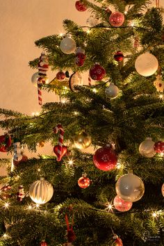 a christmas tree with ornaments and lights on it