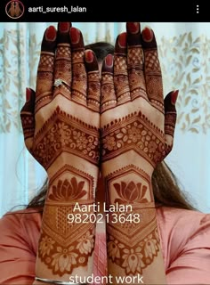 a woman with her hands covered in henna