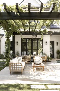 an outdoor living area with couches and tables