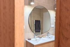 a bathroom with a sink, mirror and towel rack