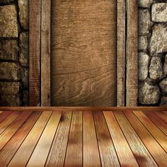 an empty room with wood floor and stone walls, as well as a wooden door