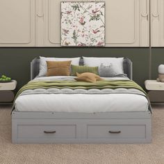 a bed with two drawers underneath it in a room that has carpeted flooring