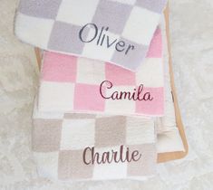 three personalized towels sitting on top of each other