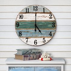 a clock that is on the side of a wall next to a book shelf and dresser