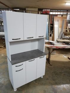 the cabinets are all white and have black tops