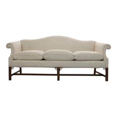 a white couch sitting on top of a wooden frame