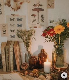 a table topped with books and vases filled with flowers