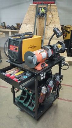 a workbench with tools on it in a garage area next to other equipment