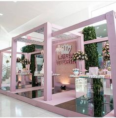 a pink store with mirrors and flowers on display