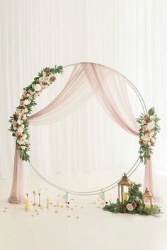 a wedding arch decorated with flowers and candles