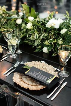 the table is set with silverware and place settings for an elegant dinner or reception