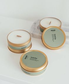 three candles sitting on top of a white counter