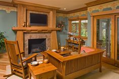 a living room filled with furniture and a flat screen tv mounted on the wall above a fireplace