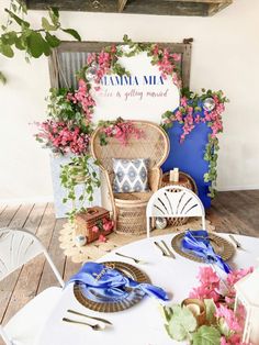 the table is set up with flowers and place settings for guests to sit down at