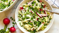 two white bowls filled with salad on top of a marble counter next to radishes