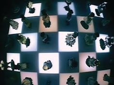 an array of chess pieces on a black and white checkerboard pattern with light shining through them