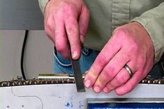 a man holding a knife in his hand while standing next to a piece of luggage